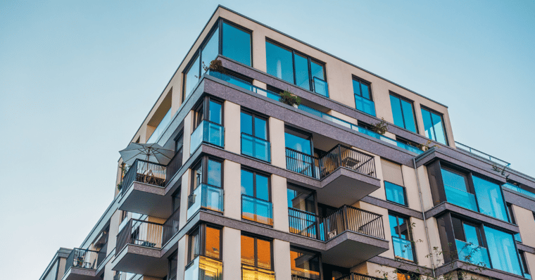 modern corner apartment complex with blue coloured windows