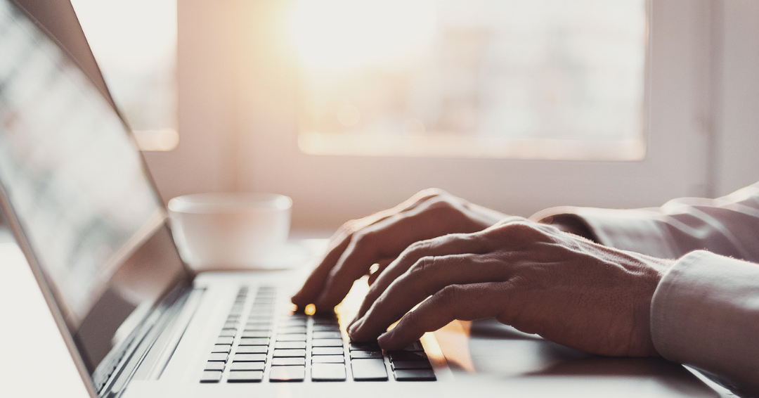 hands typing on laptop