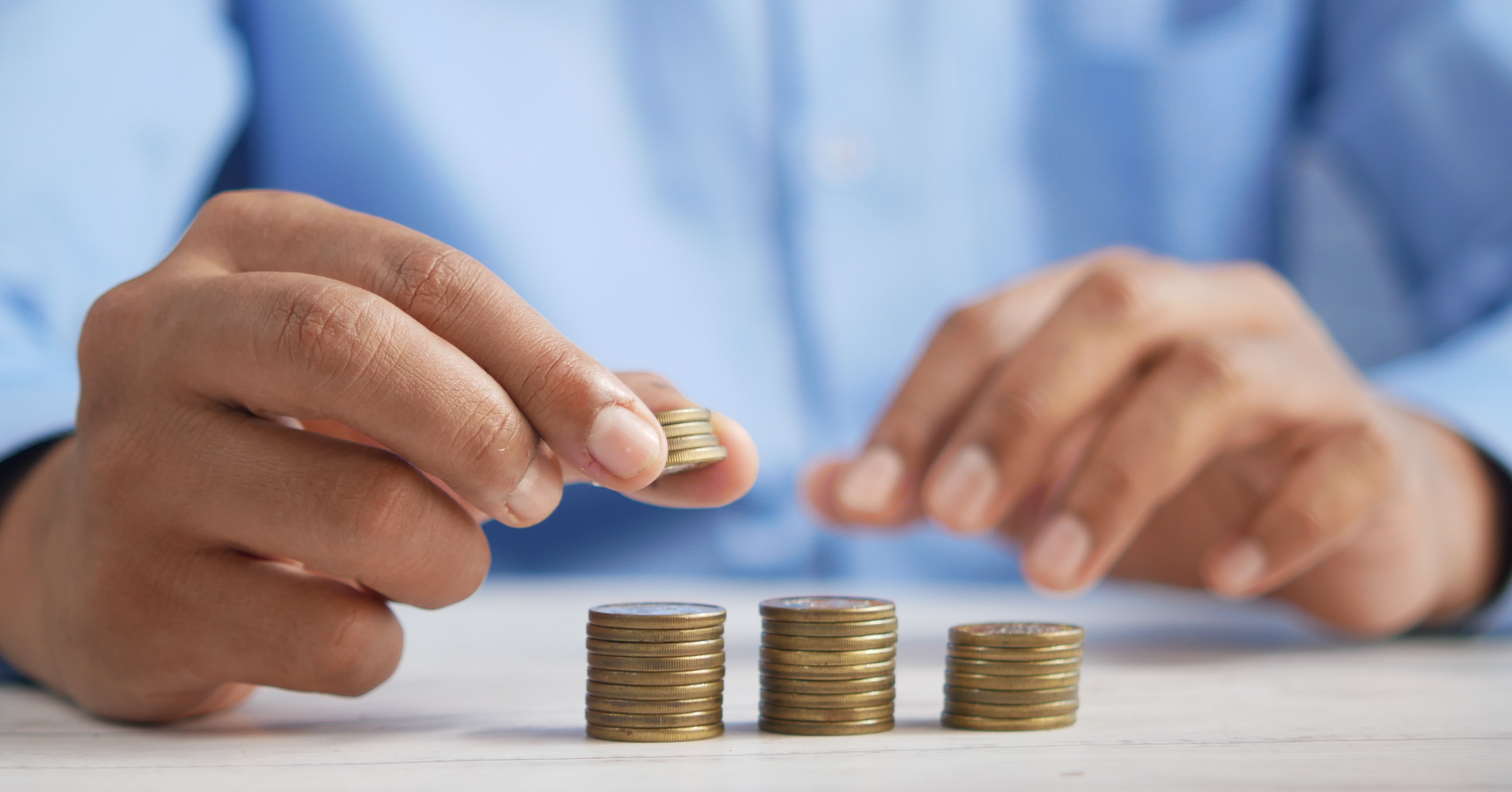 person stacking coins