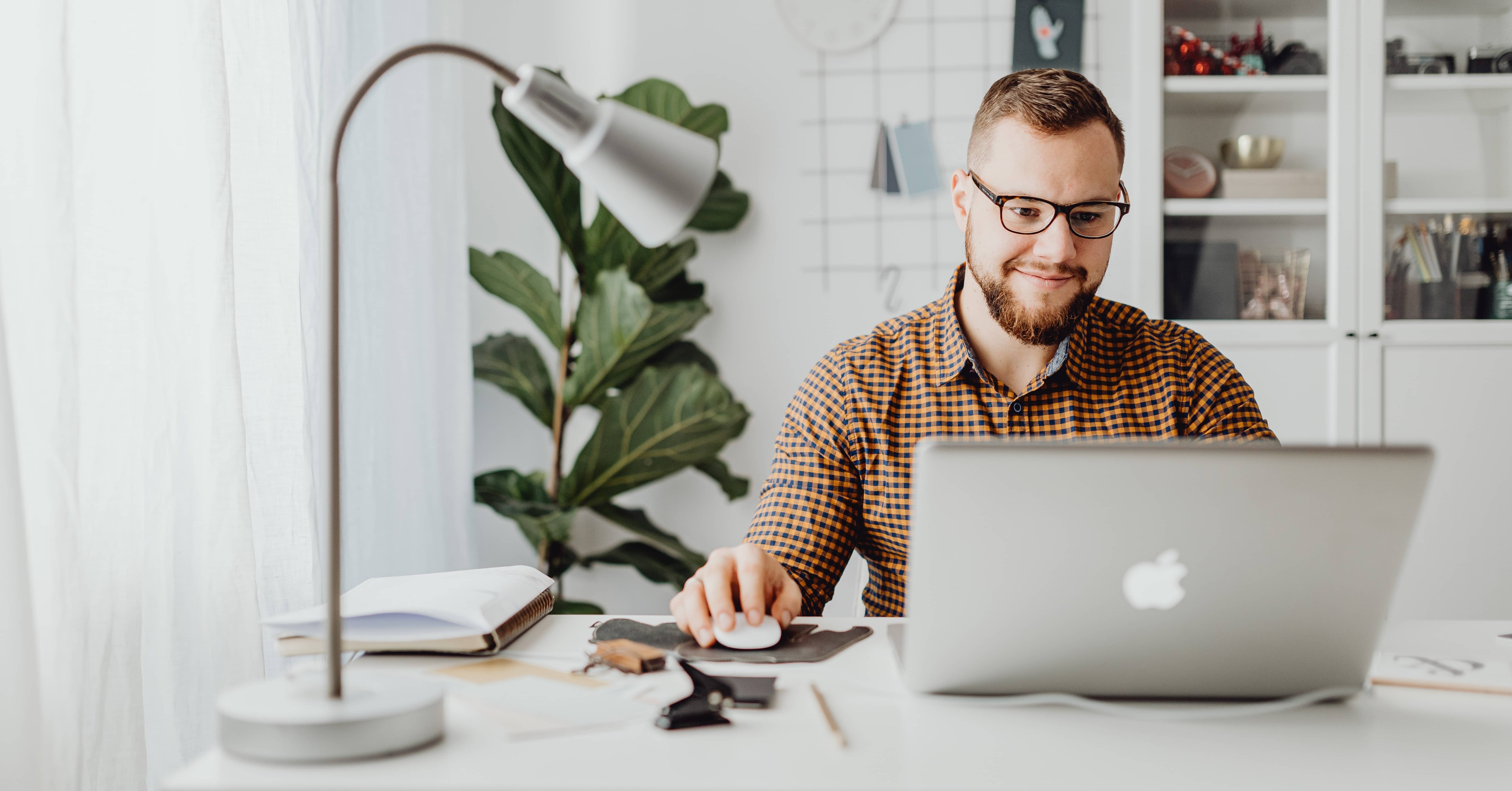 man sat at desk with computer